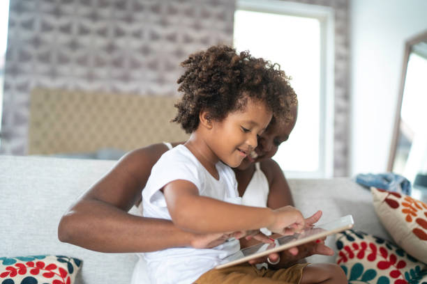 istock Mother and son playing with digital tablet 1146789751