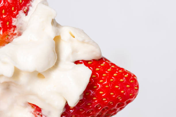 istock Red fresh strawberries in white milk cream closeup. 1146789866