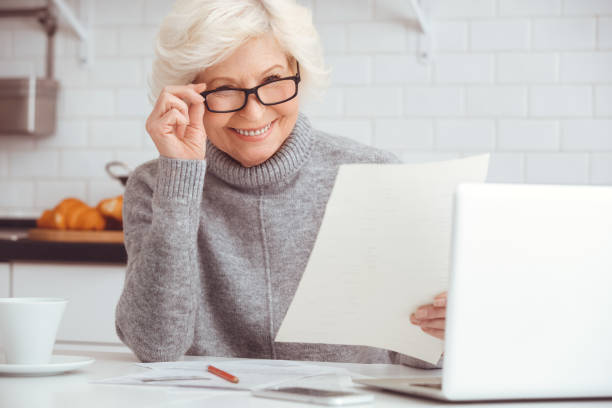 istock Grandma works at home at the computer. 1146790661