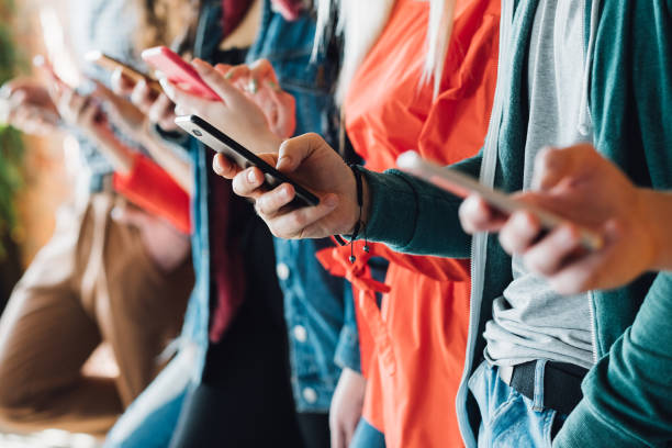 millennial generation modern devices technology Millennial generation. Colorful cropped closeup of young people holding smartphones. Modern devices. Technological progress. creation stock pictures, royalty-free photos & images