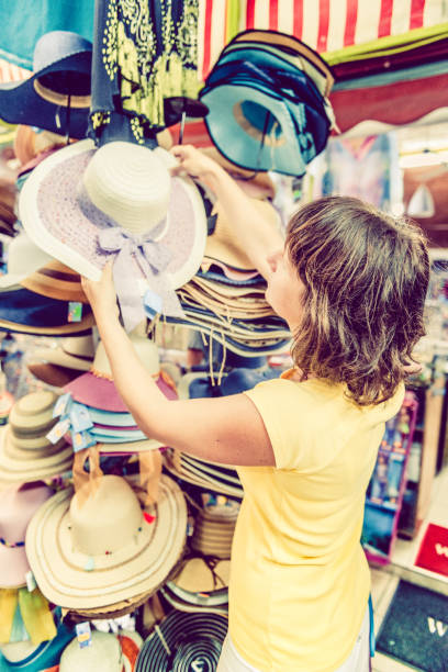 istock woman buying hat 1146792659