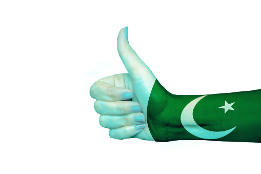 Pakistan flag painted on hand showing thumbs up in isolated background