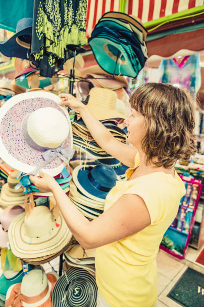istock woman buying hat 1146793636