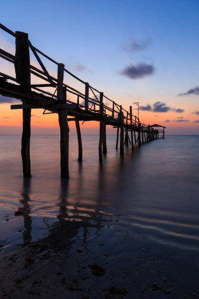 istock Abstract Old wooden jetty pier long exposure during beautiful sunset 1146795070