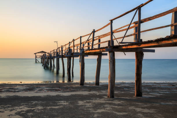 istock Abstract Old wooden jetty pier long exposure during beautiful sunset 1146795072