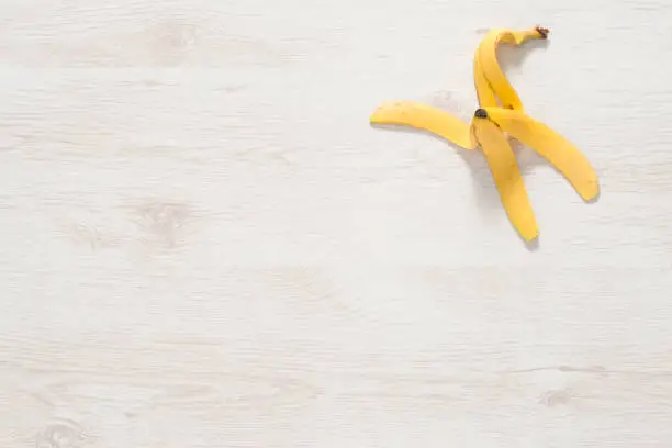Banana peel on white wooden surface for backgrounds