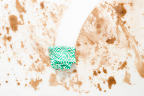 Green cloth or rag wiping clean a dirty counter top or floor