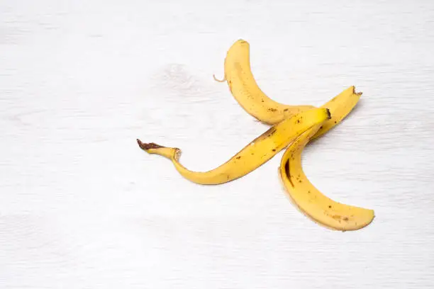 Banana peel isolated on a white wooden background