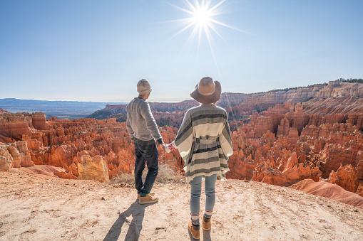 Young couple travel Bryce Canyon national park in Utah, United States, people travel explore nature. Couple hiking in red rock formations