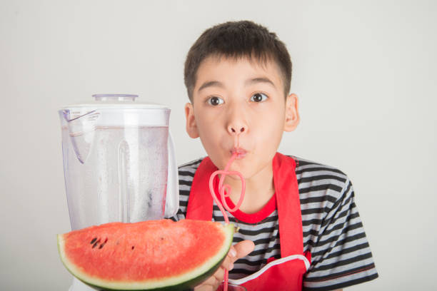 istock Little boys blend water melone juice by using blender at home 1146816974
