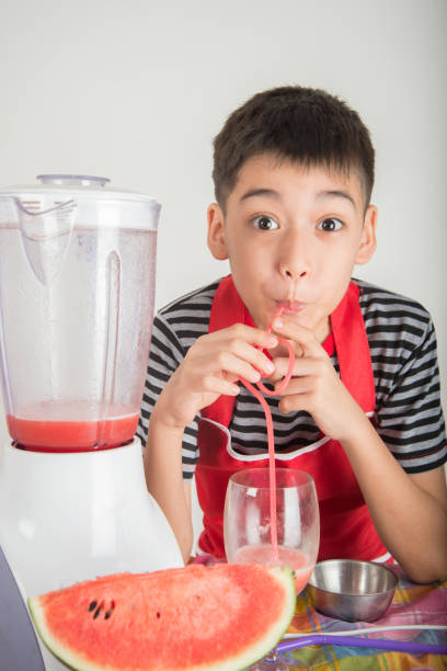 istock Little boys blend water melone juice by using blender at home 1146816982