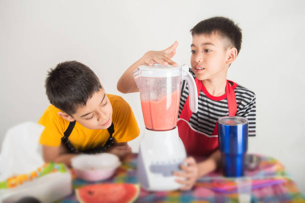 istock Little boys blend water melone juice by using blender at home 1146817062