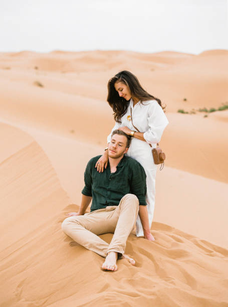 istock Loving couple in Sahara Desert. 1146819930