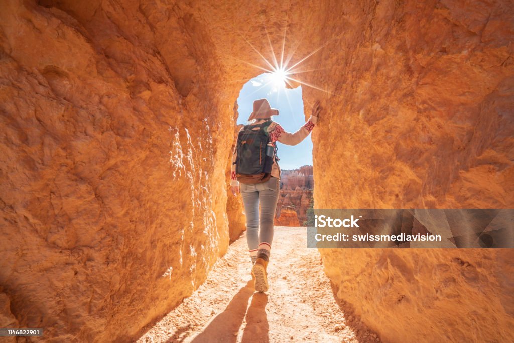 Young woman travels Bryce Canyon national park in Utah, United States, people travel explore nature. Girl hiking in red rock formations Utah Stock Photo