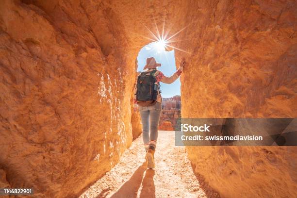 Young Woman Travels Bryce Canyon National Park In Utah United States People Travel Explore Nature Girl Hiking In Red Rock Formations Stock Photo - Download Image Now