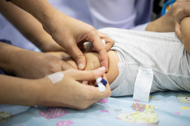 Many doctors and nurses are helping to vaccinate to protect a disease for a baby. Many doctors and nurses are helping to vaccinate to protect a disease for a baby. babyproof stock pictures, royalty-free photos & images