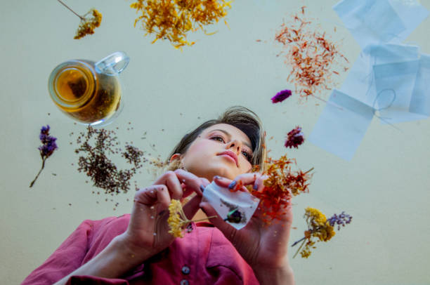 istock View at a young girl from under glass table while she prepares leaves before brew a tea 1146824582