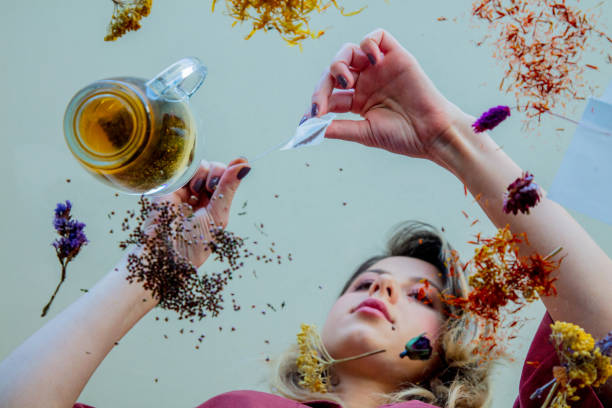 istock View at a young girl from under glass table while she prepares leaves before brew a tea 1146824583