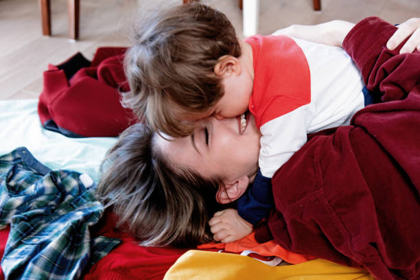 istock Young mother and toddler boy hugging on a floor 1146824588