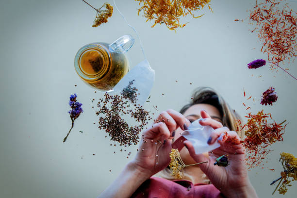 istock View at a young girl from under glass table while she prepares leaves before brew a tea 1146824589
