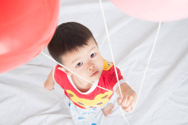 istock Boy  sibling with balloon  heart shape of love 1146830652
