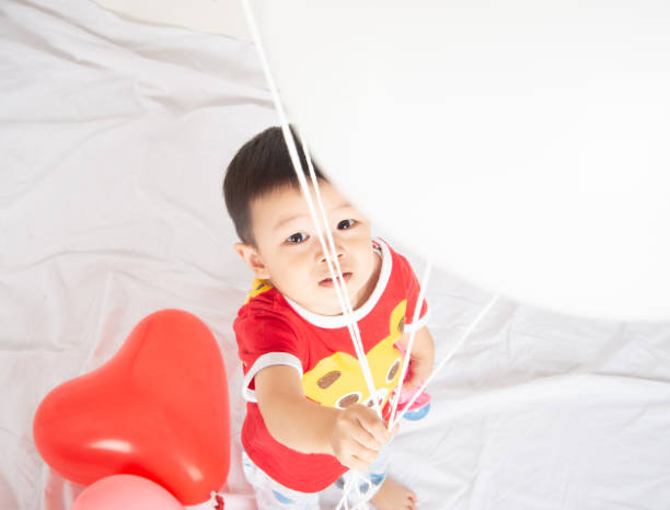 istock Boy  sibling with balloon  heart shape of love 1146831244