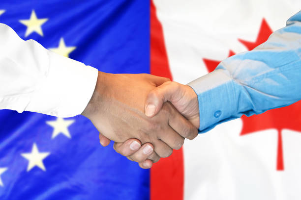 istock handshake on European Union and Canada flag background. 1146831289