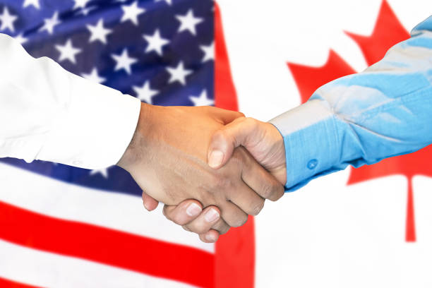 istock handshake on Canada and USA flag background. 1146831331