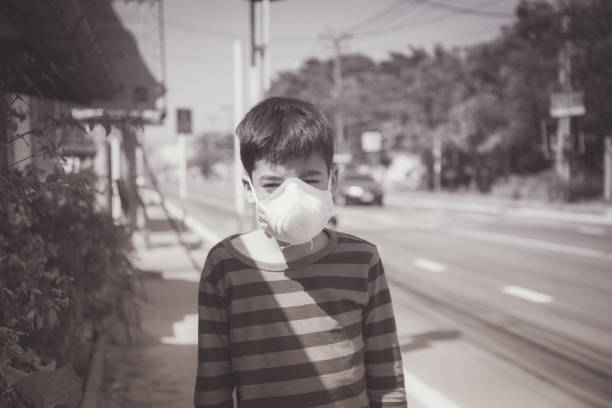 istock Little boy using Dust Respirator Folding Protection Mask PM2.5 Ear Head Hang 1146831375