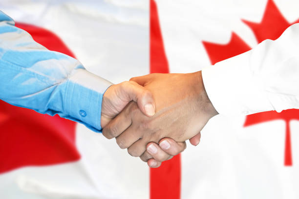 istock handshake on Canada and Japan flag background. 1146831384