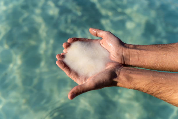istock male hands holding salt from the dead sea 1146833524