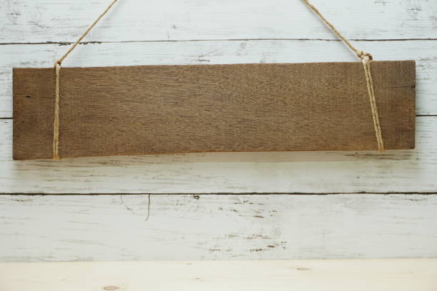 istock space copy wood sign hanging on rustic wooden background 1146835461