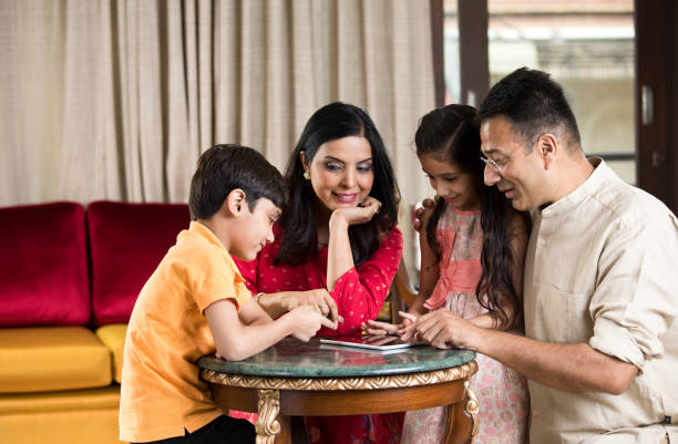 istock Indian family playing game on digital tablet 1146836288
