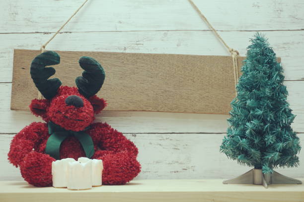 istock space copy on wooden hanging and red reindeer doll with christmas tree and simulation candle light 1146836384