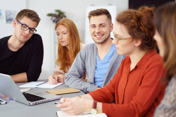istock Smiling confident young man in a business meeting 1146839138