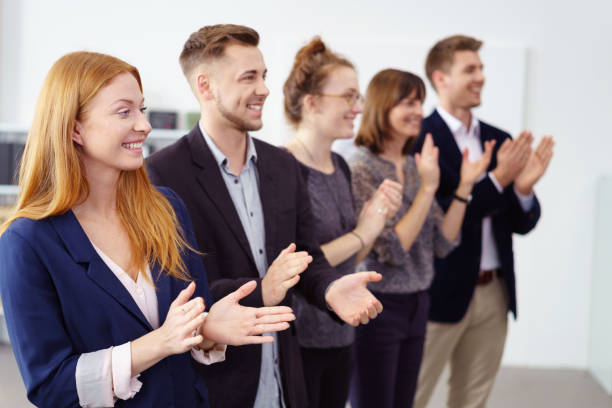 istock Row of impressed co-workers clapping a colleague 1146839340