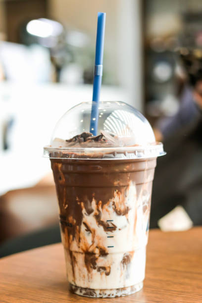 istock Iced rich chocolate in take a way cup on wooden table at coffee shop. 1146839421