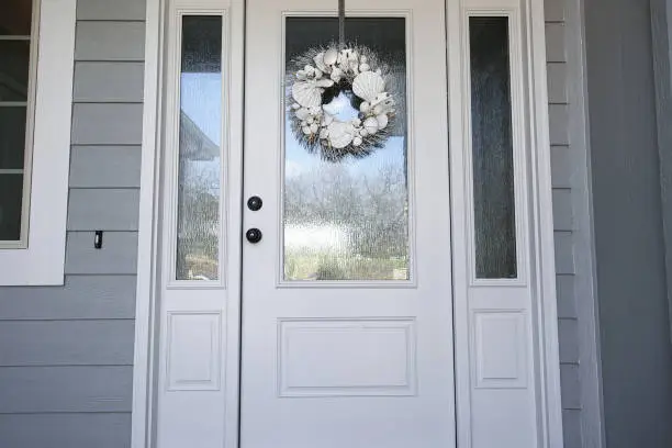 seashell wreath on white front door