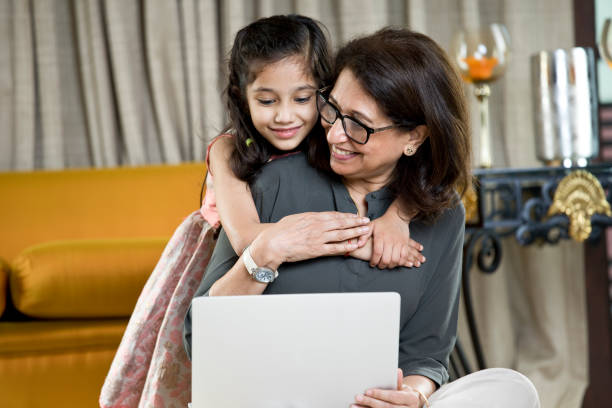 istock Grandmother with granddaughter using laptop at home 1146841483