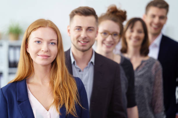 istock Attractive young businesswoman posing with a team 1146841503