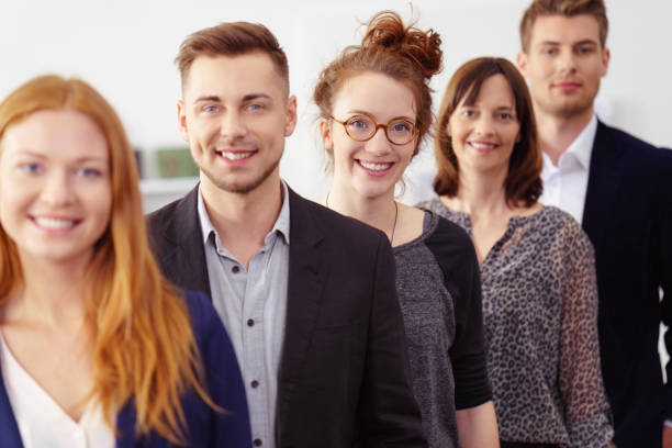 istock Smiling group of young professionals in office 1146844837