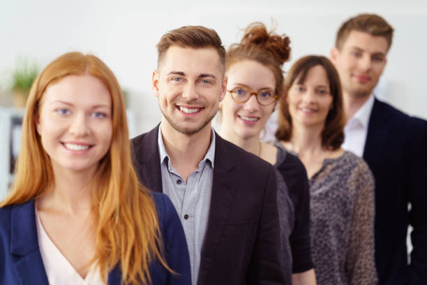 istock Smiling group of young professionals stand in line 1146844882
