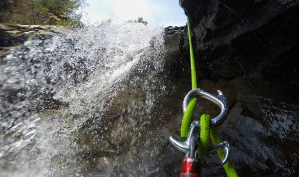Canyoning Descending down a waterfall canyoneering stock pictures, royalty-free photos & images