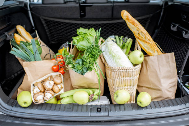 Car trunk with shopping bags and products Car trunk with shopping bags full of fresh and healthy food trunk stock pictures, royalty-free photos & images