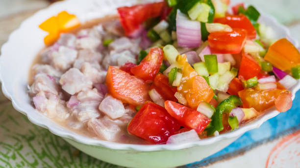 istock Typical raw fish dish, ceviche. With vegetables, onion, red and green pepper, tomato and lemon juice 1146852256