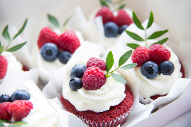 istock Appetizing cupcakes with white cream, raspberries and blueberries 1146858484