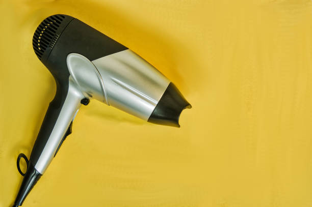 istock Hair dryer on yellow background 1146858666