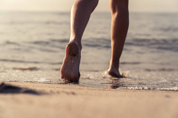 istock Woman legs. Beach scene 1146859862