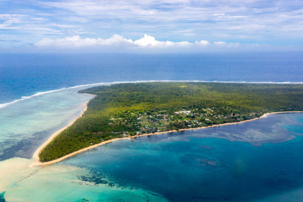Aerial view of rural Uiha Island near Lifuka, the Haapai Group, Ha'apai, Ha'apai islands, Kingdom of Tonga, Polynesia, Oceania, South Pacific Ocean. Palms, yellow sandy beaches and villages stock photo