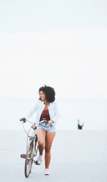 istock Colombian young woman riding a bicycle. 1146861456